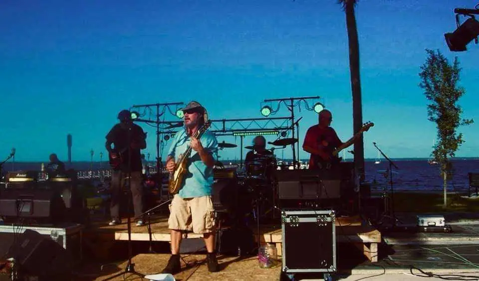 Daytime festival performance beneath a blue sky